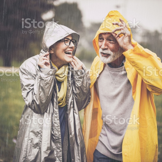 woman and a man standing in a rain.